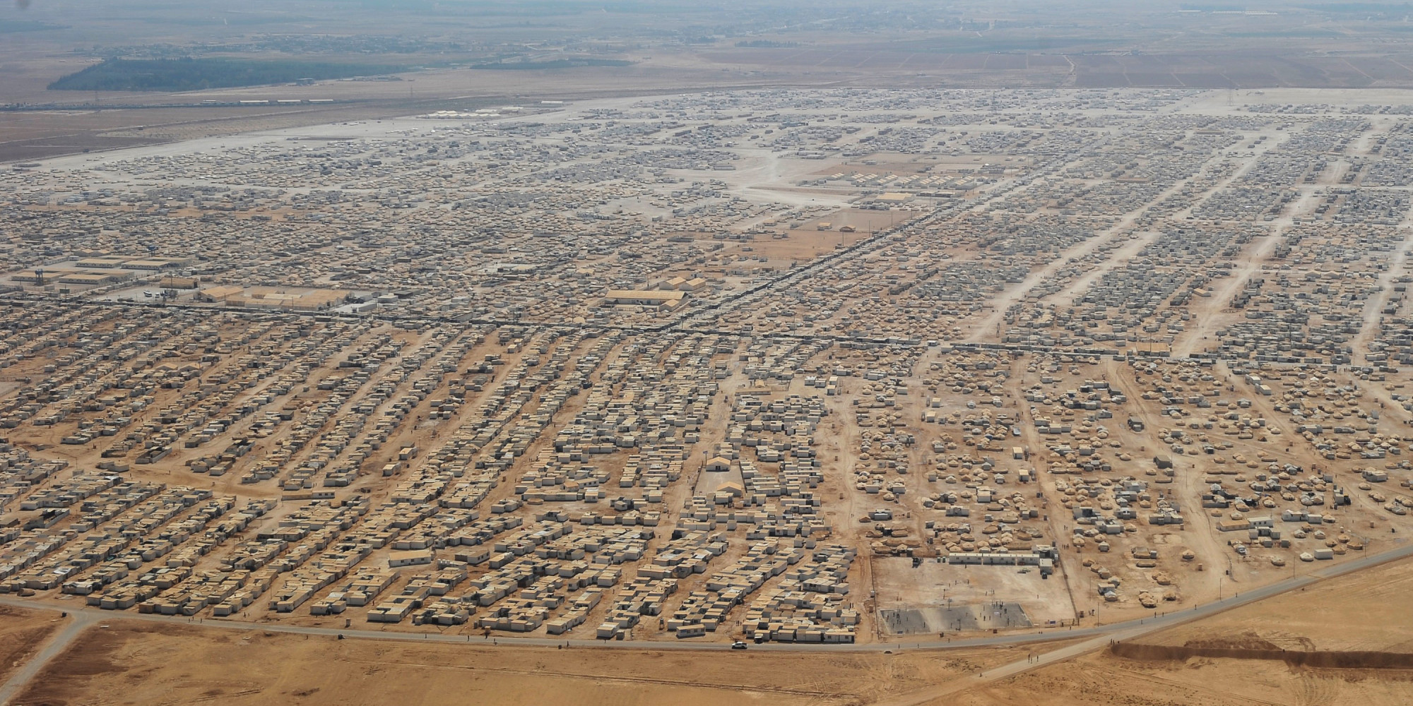 An aerial view shows the Zaatari refugee camp on July 18, 2013 near the Jordanian city of Mafraq, some 8 kilometers from the Jordanian-Syrian border. The northern Jordanian Zaatari refugee camp is home to 115,000 Syrians. AFP PHOTO/MANDEL NGAN/POOL