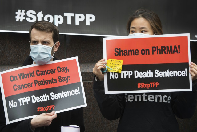 Cancer patients and survivors, health professionals and others protest the Trans-Pacific Partnership (TPP) trade deal outside of PhRMA, the Pharmaceutical Research and Manufacturers of America, in Washington, DC, February 4, 2016. Cancer patients and survivors, health professionals and others demonstrated outside the trade group's offices against the TPP, which they say will prevent access to life-saving generic medicines and increase drug costs. / AFP / Saul Loeb        (Photo credit should read SAUL LOEB/AFP/Getty Images)